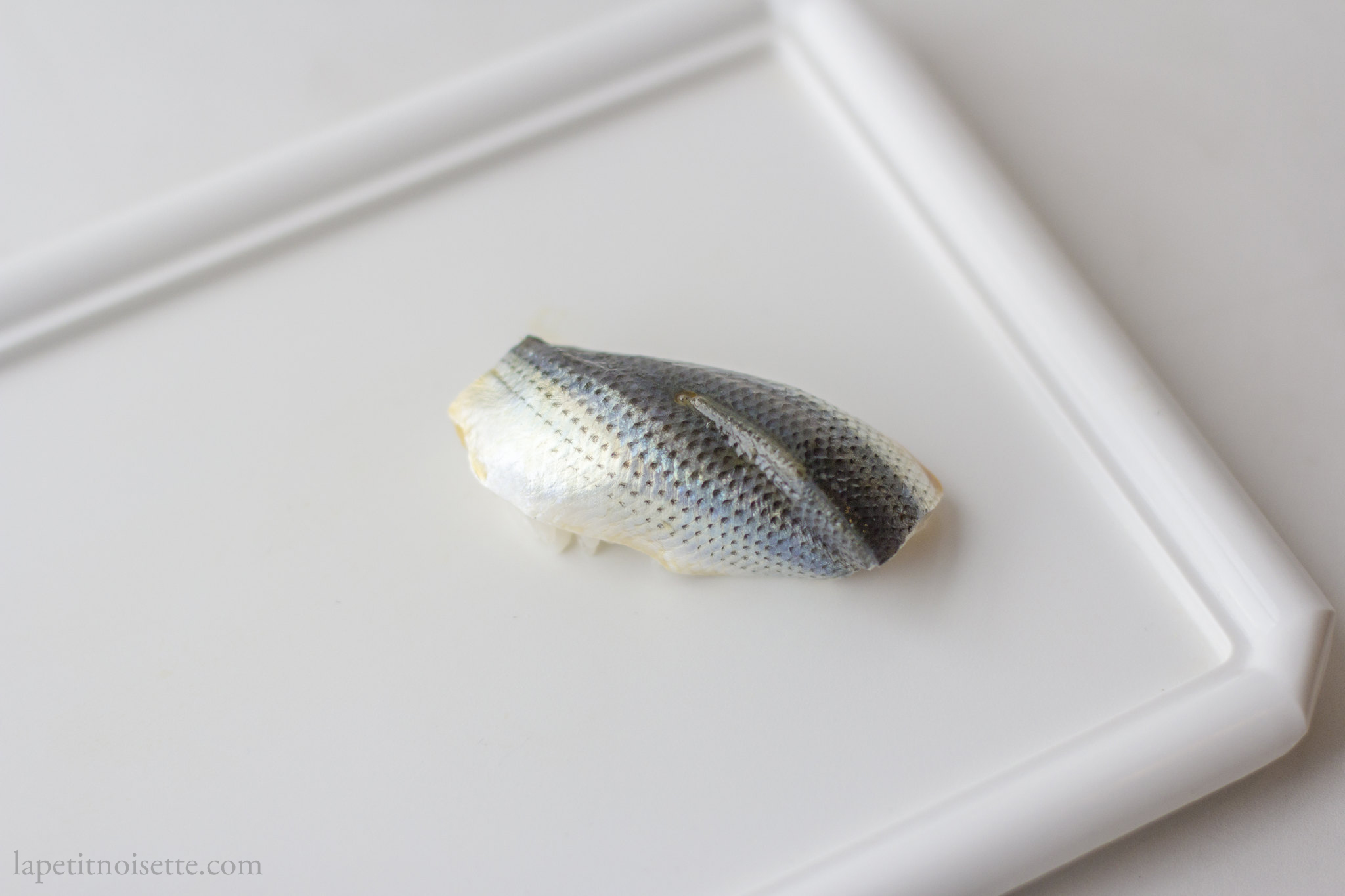 A piece of Gizzard Shad twisted when made into sushi to express liveliness.