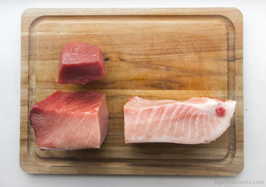 A block of tuna being cut into individual sections.