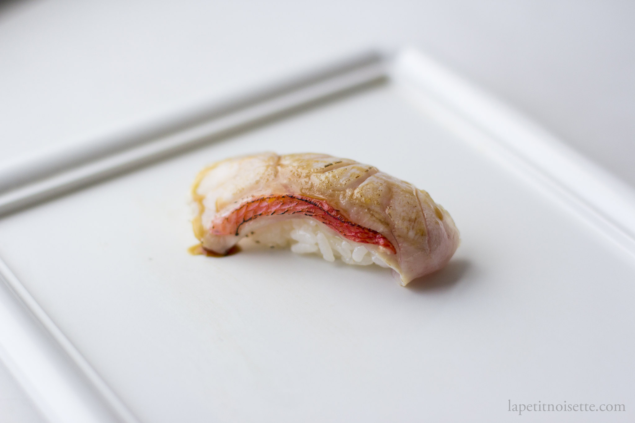 Seared kinmedai nigiri sushi.