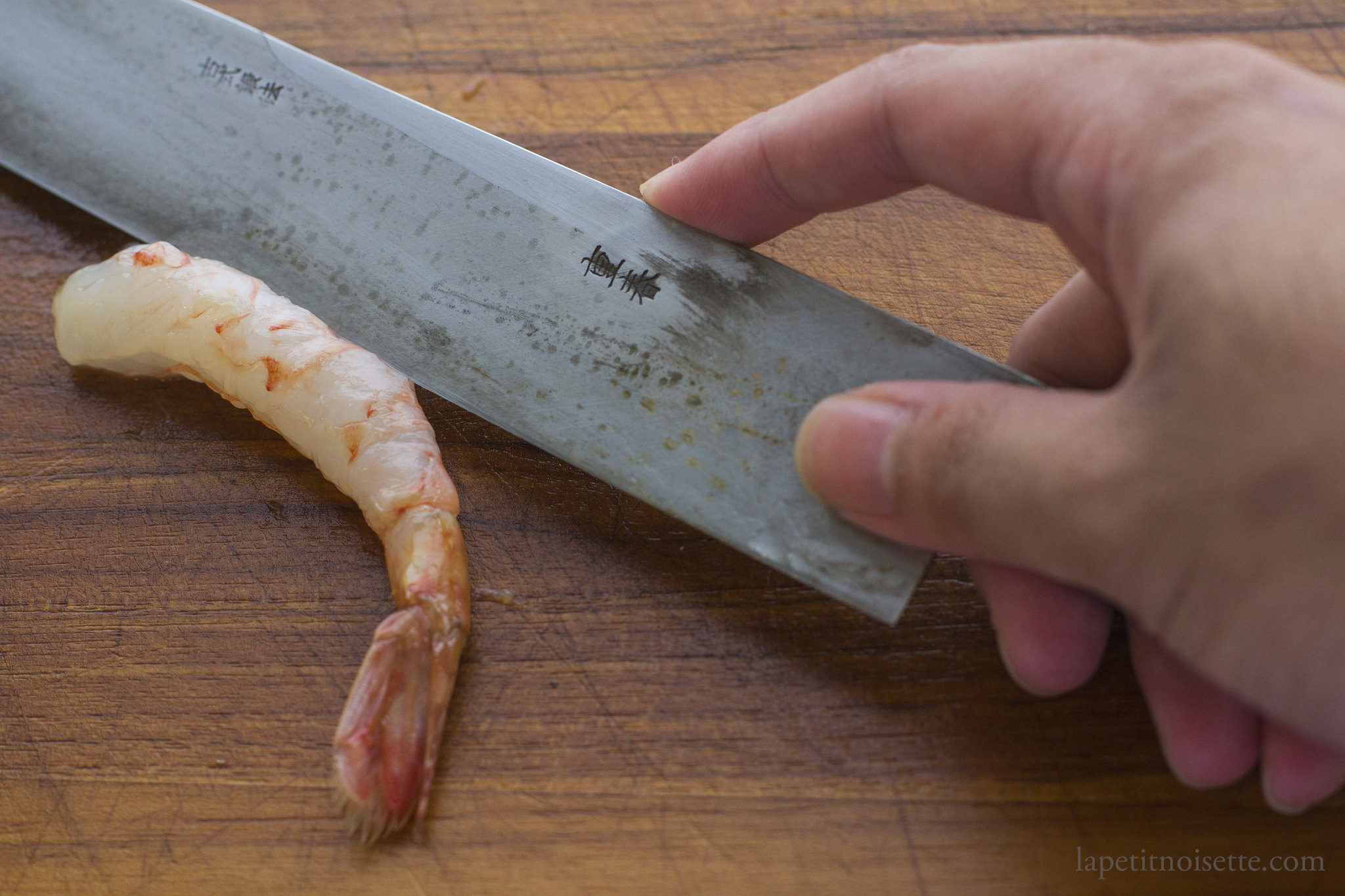 Removing the guts of a botan shrimp for sushi.