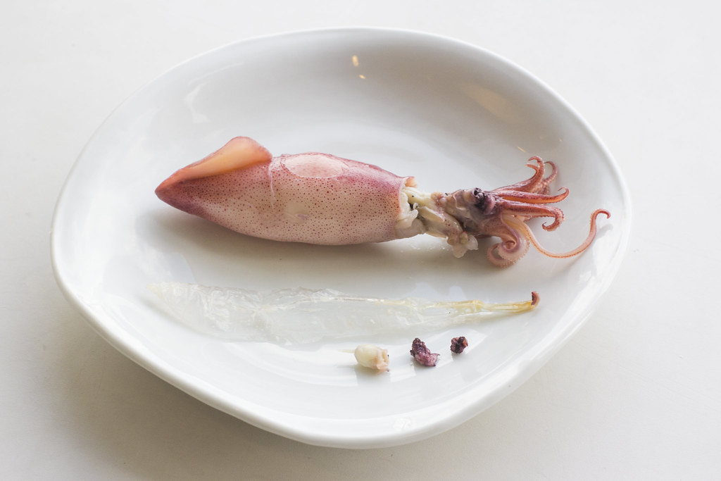 The gladius, eyes and beak of a firefly squid removed for sushi preparation.