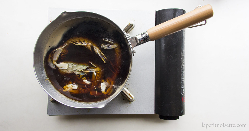 Cooking the mantis shrimp in a soy liquid for sushi.