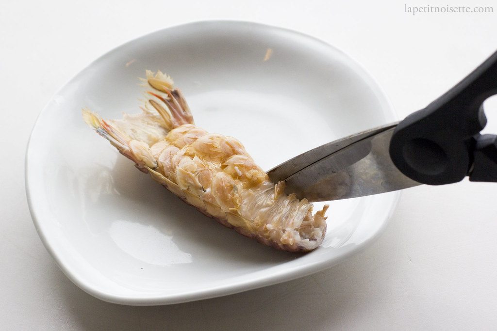 Removing the shell of mantis shrimp for sushi.