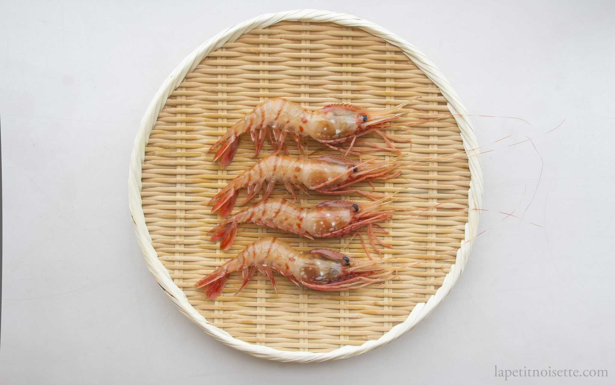 Four Botan shrimp showing the difference in freshness through a darker head colour.