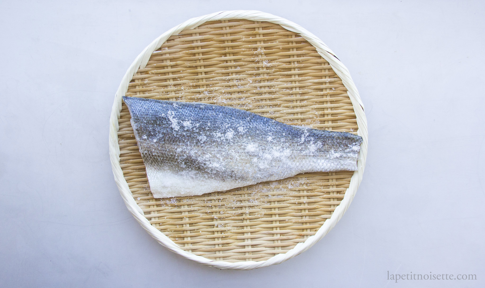 Salting Japanese sea bass for making nigiri.