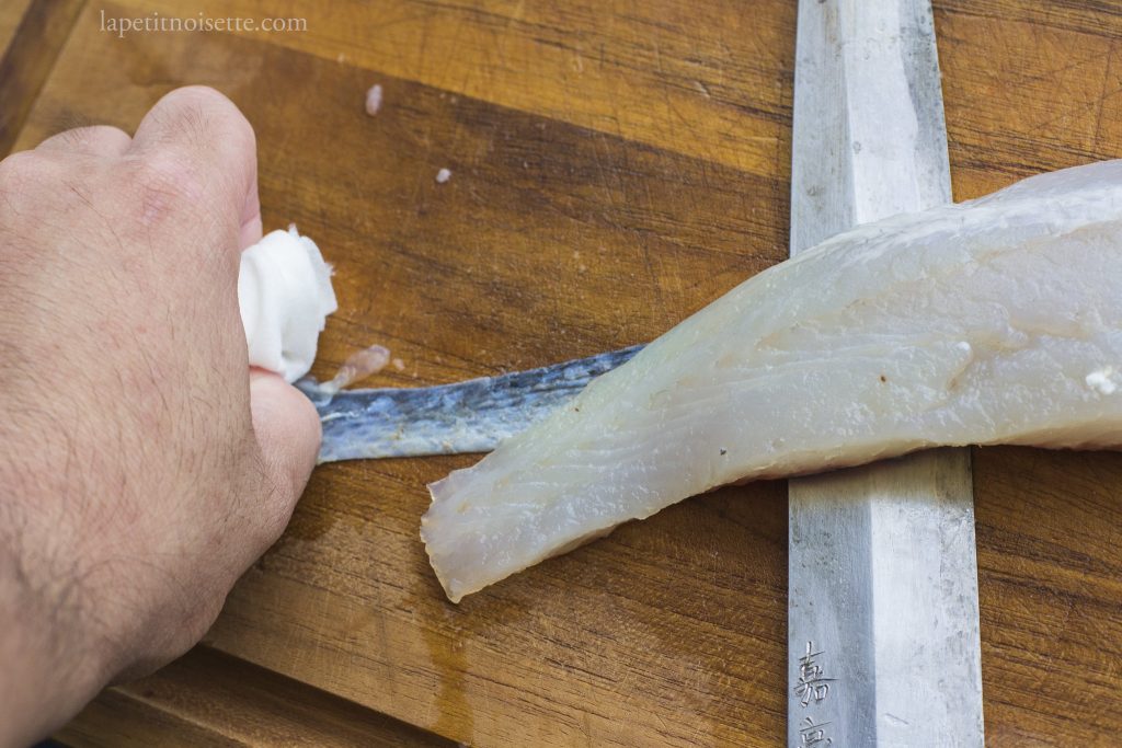 Removing the skin on a fillet of Japanese sea bass.