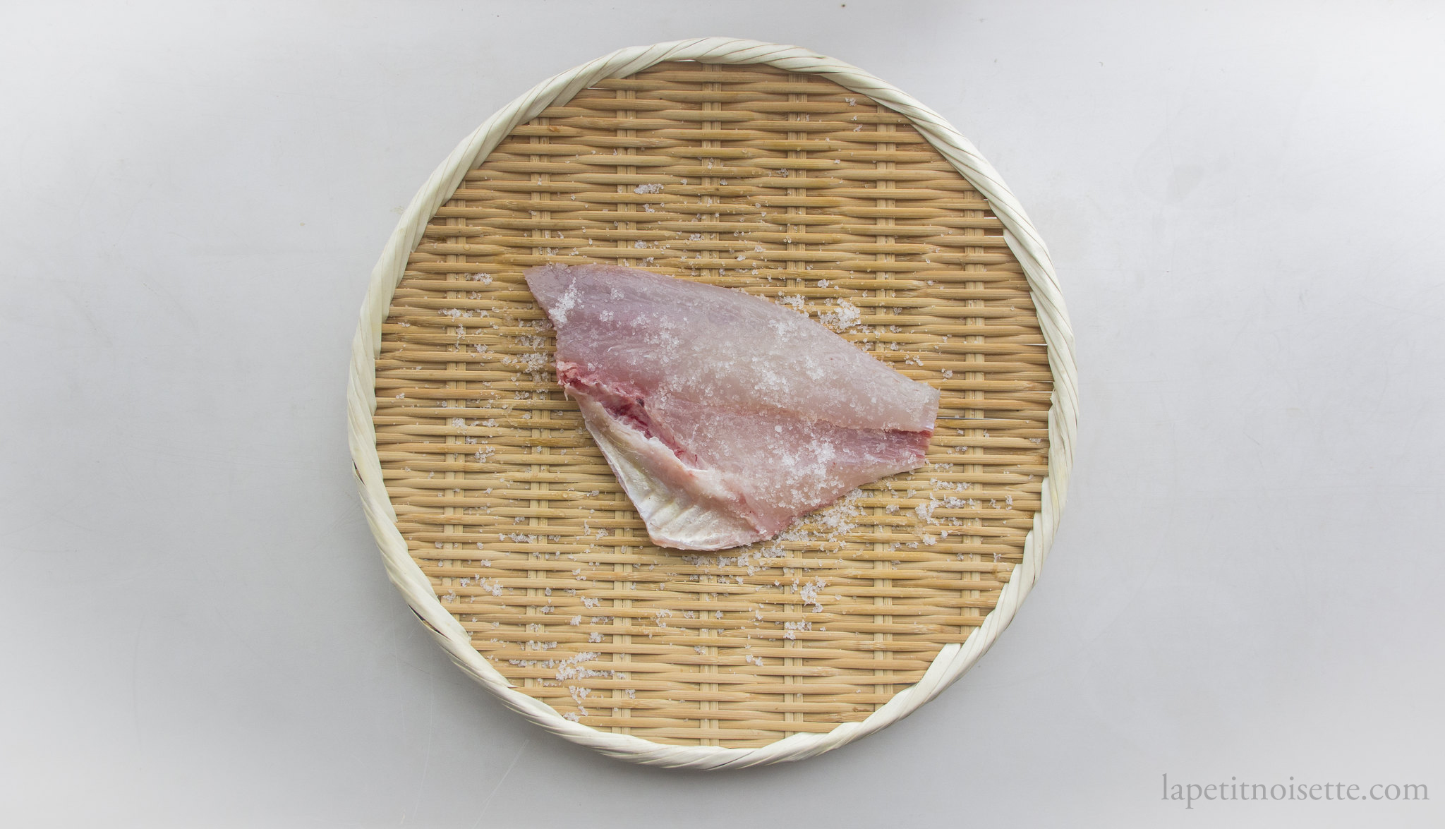 Salting a fillet of Japanese Sea Bream for edomae sushi.