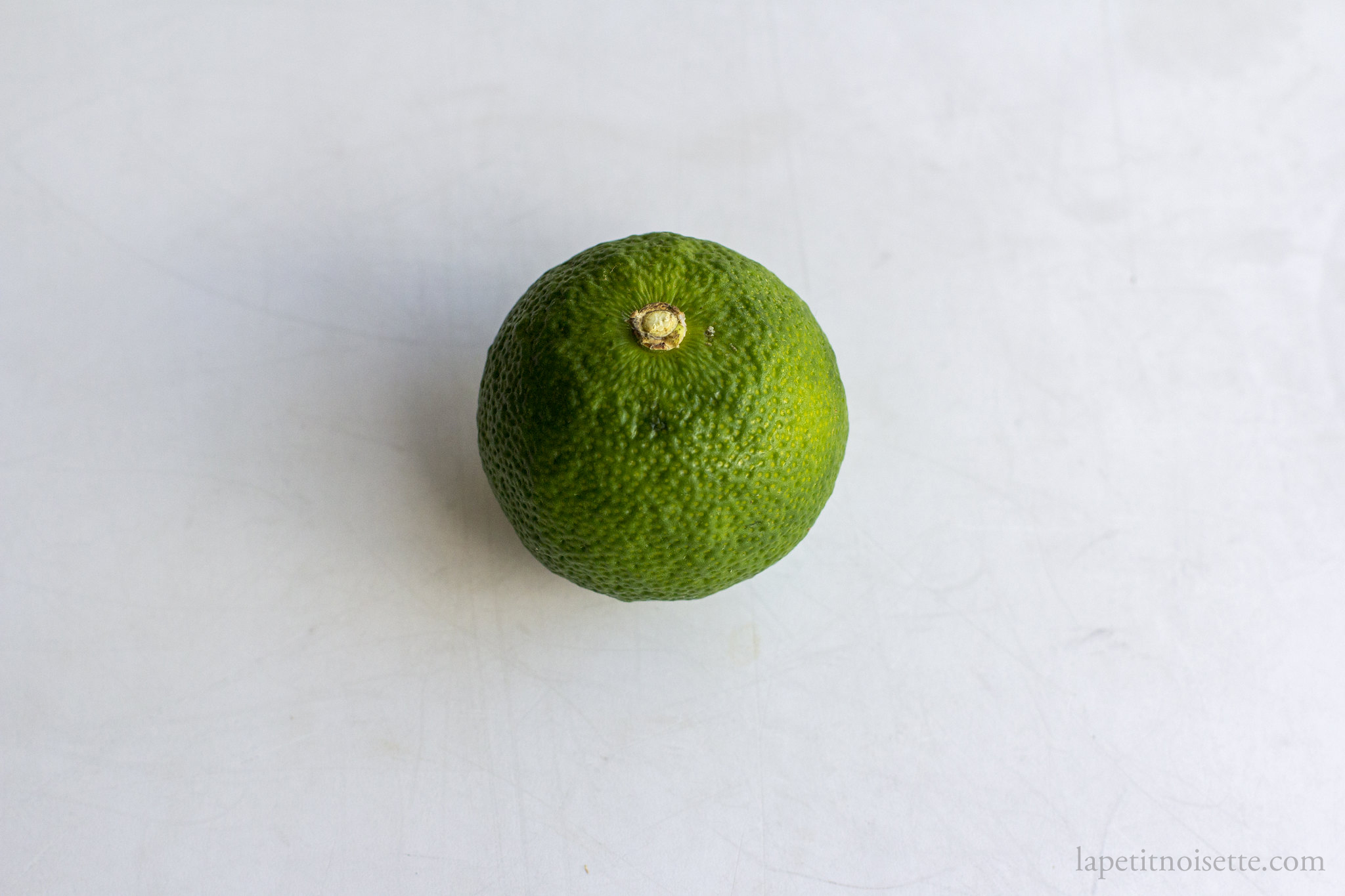 Sudachi lime used to marinade Shima Aji for edomae sushi.