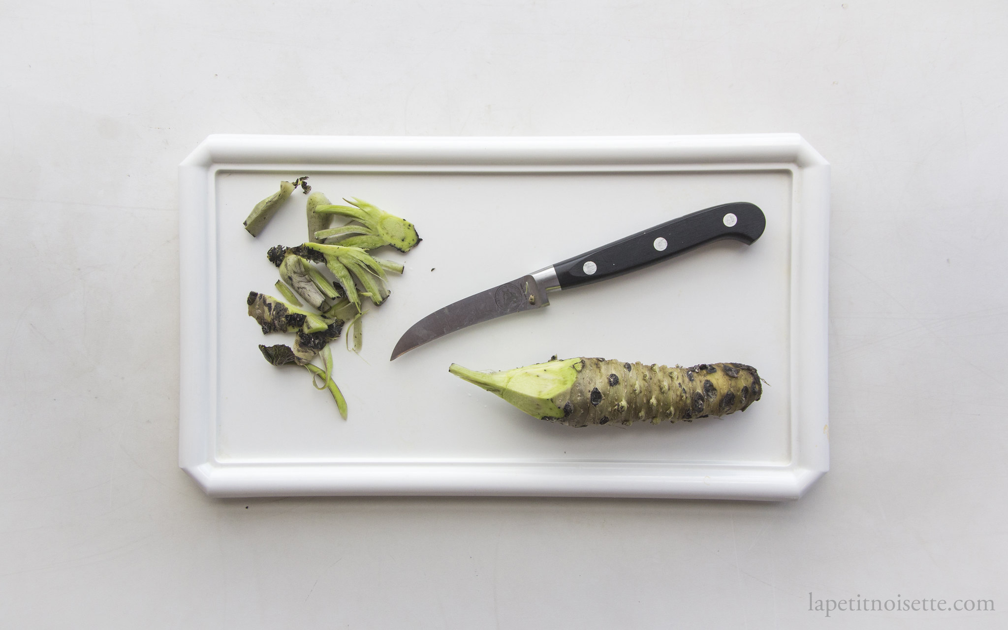 Turning wasabi with a knife.