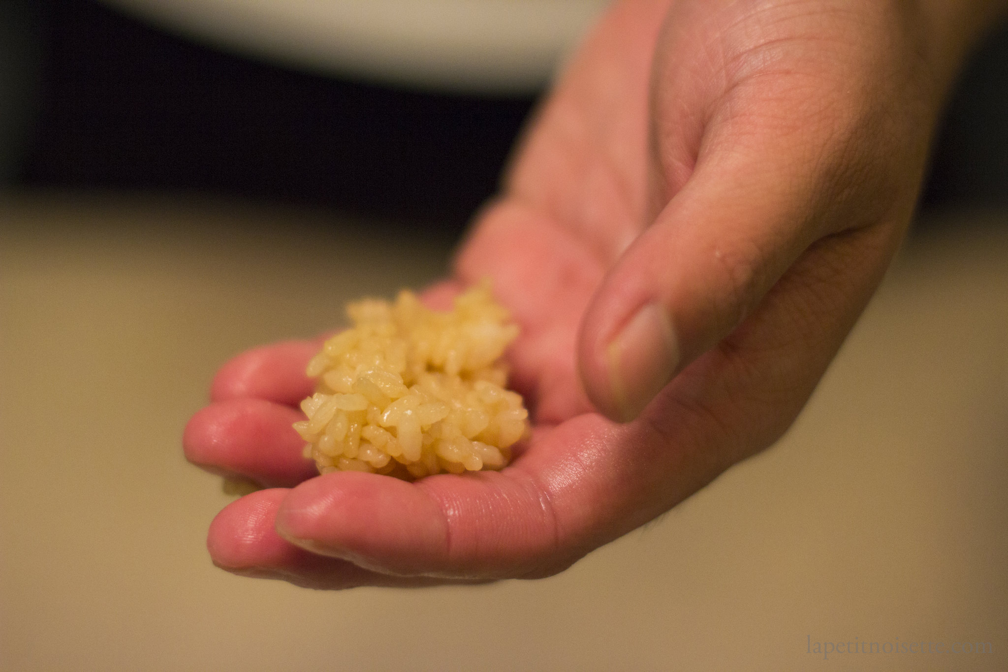 Shaping rice into a ball using one hand when making nigiri.