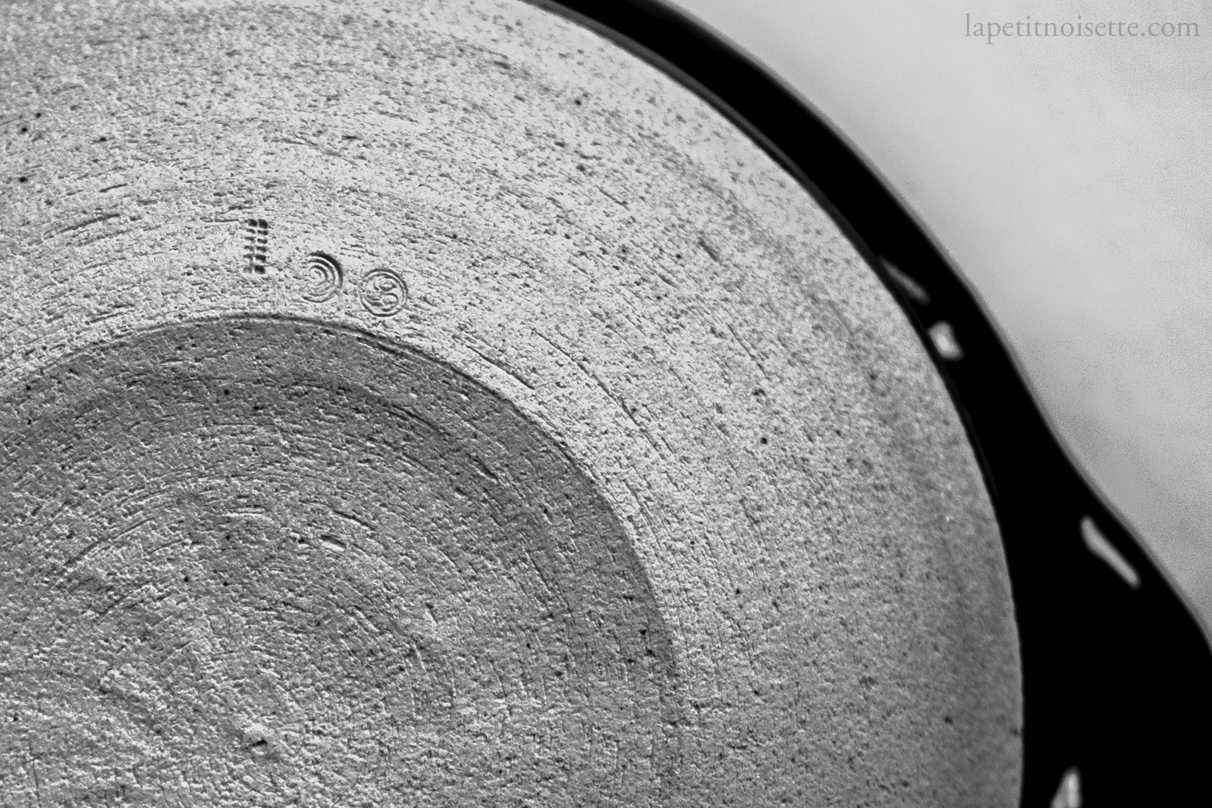 The logo of kobo kiln and Azmaya imprinted on the bottom of the their clay pot donabe.