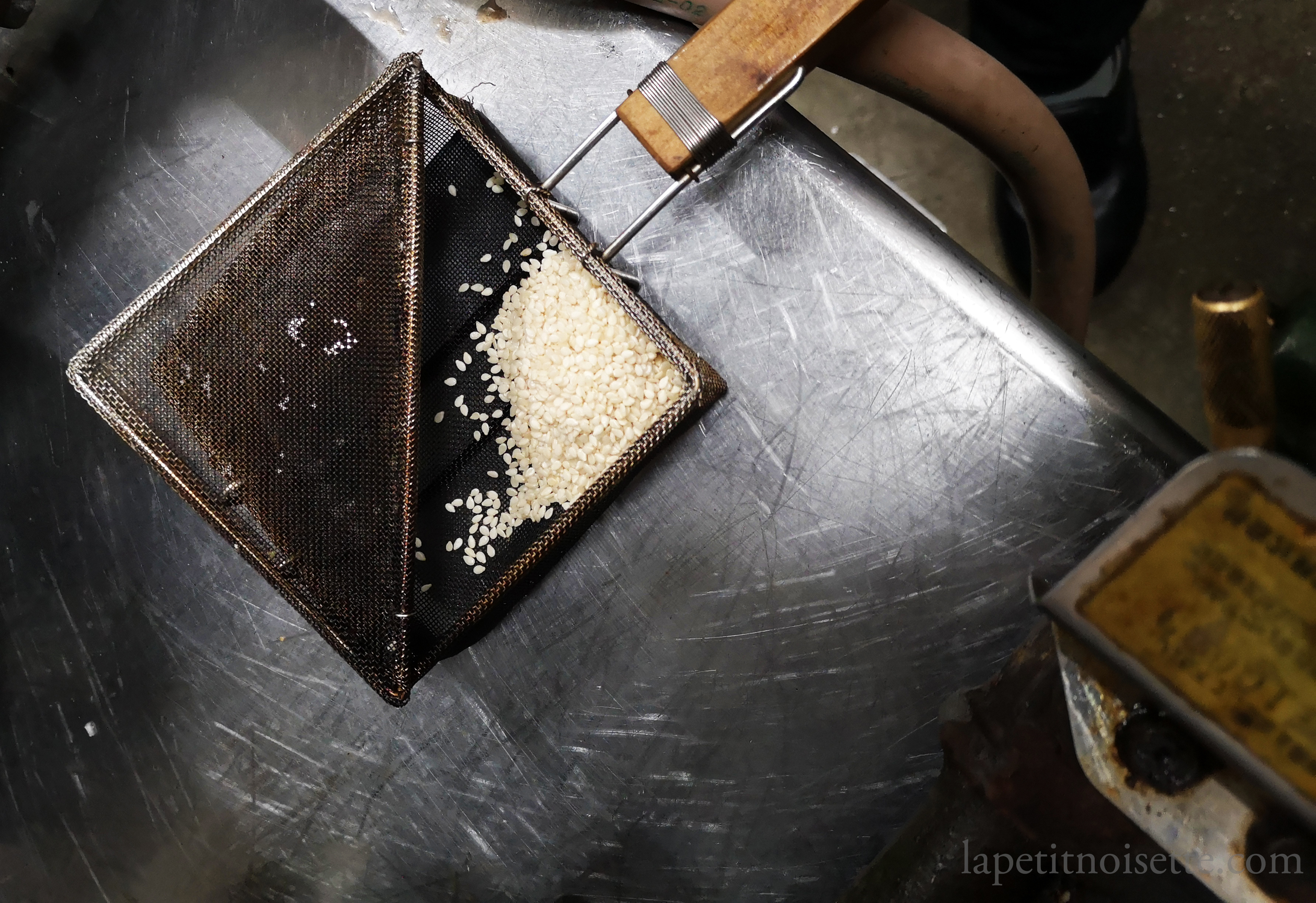 Toasting sesame seeds in a Japanese wired basket.