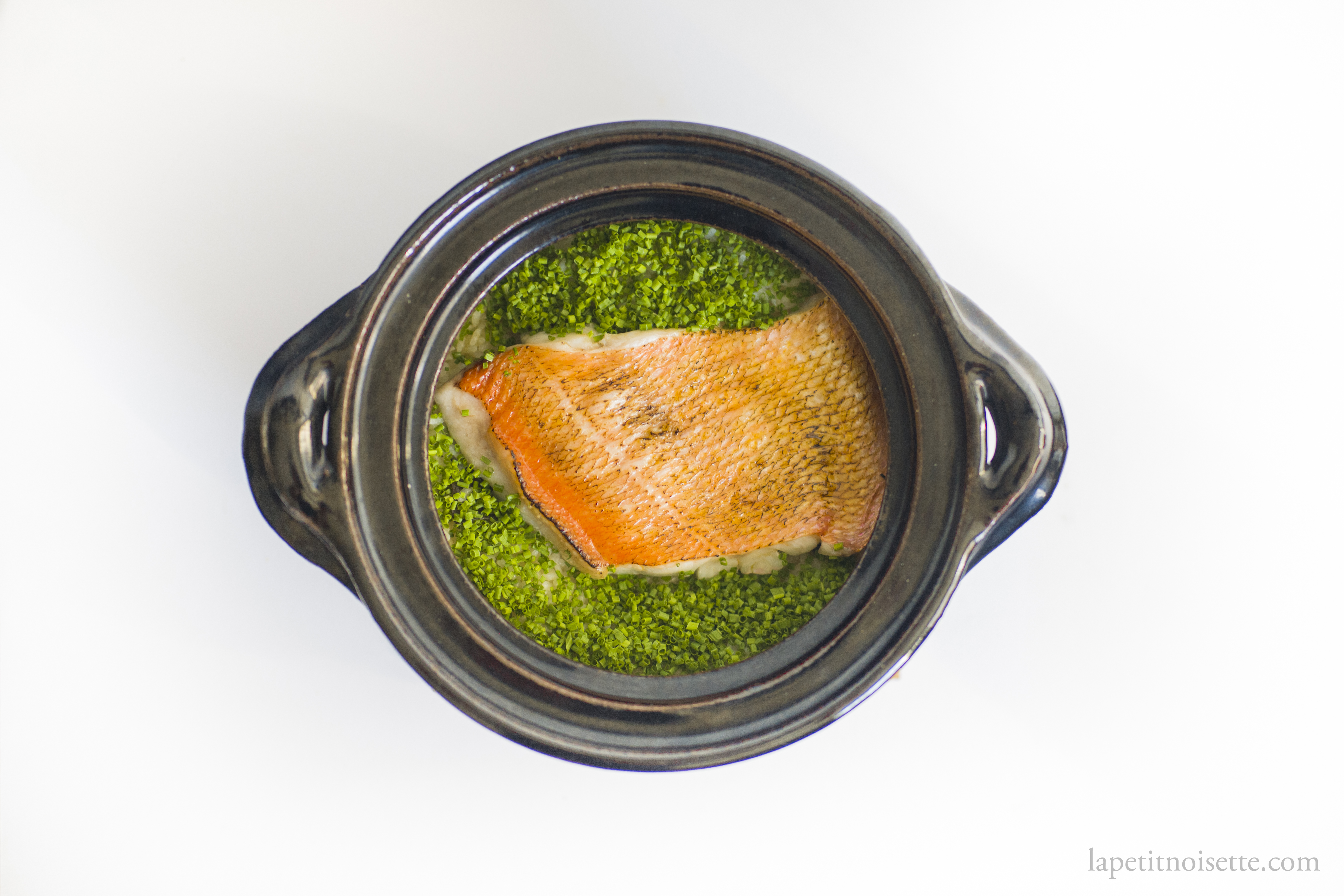 Kinmedai fish rice cooked in a clay pot donabe with chopped chives.