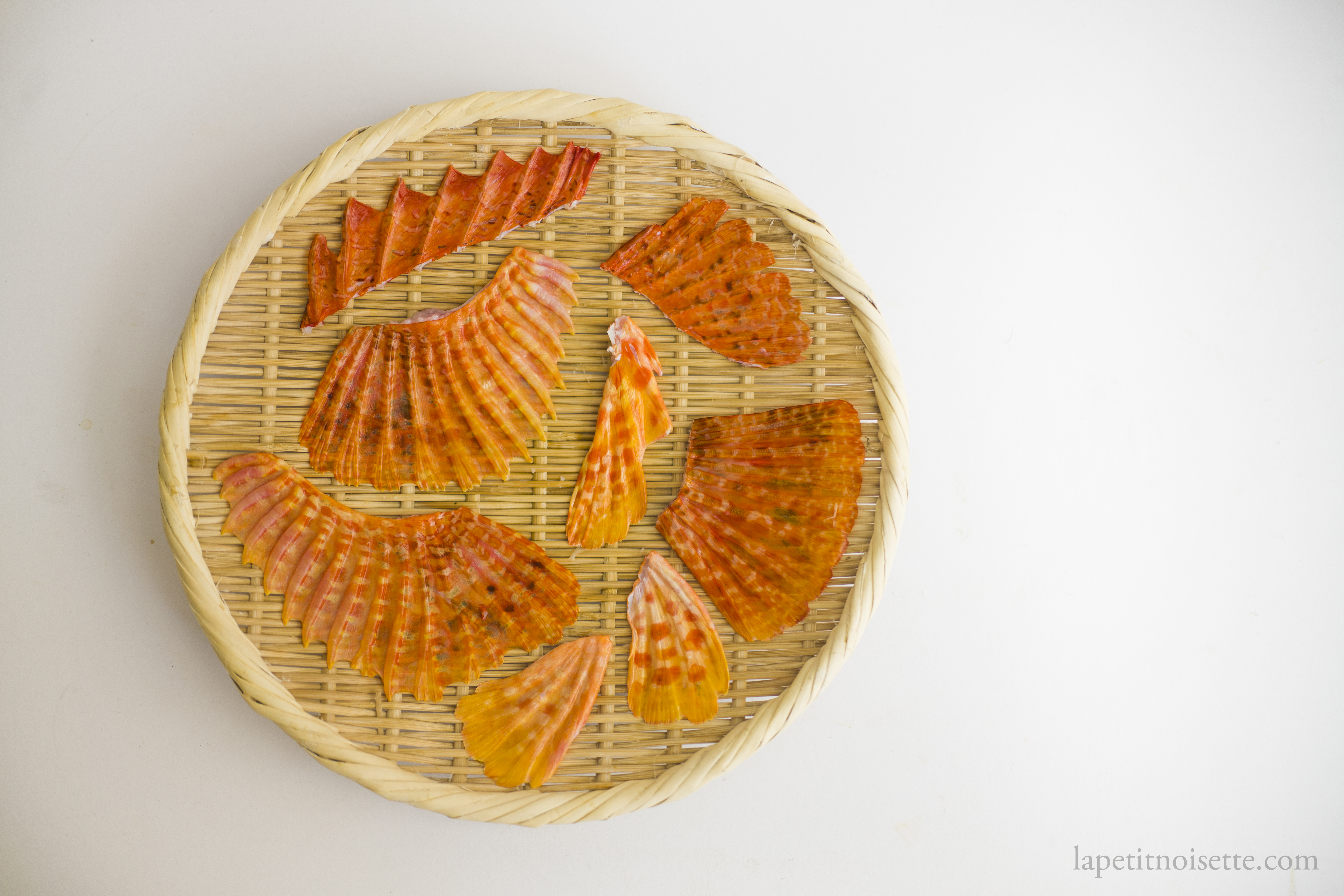 Japanese scorpionfish fins drying in the sun on a bamboo colander.