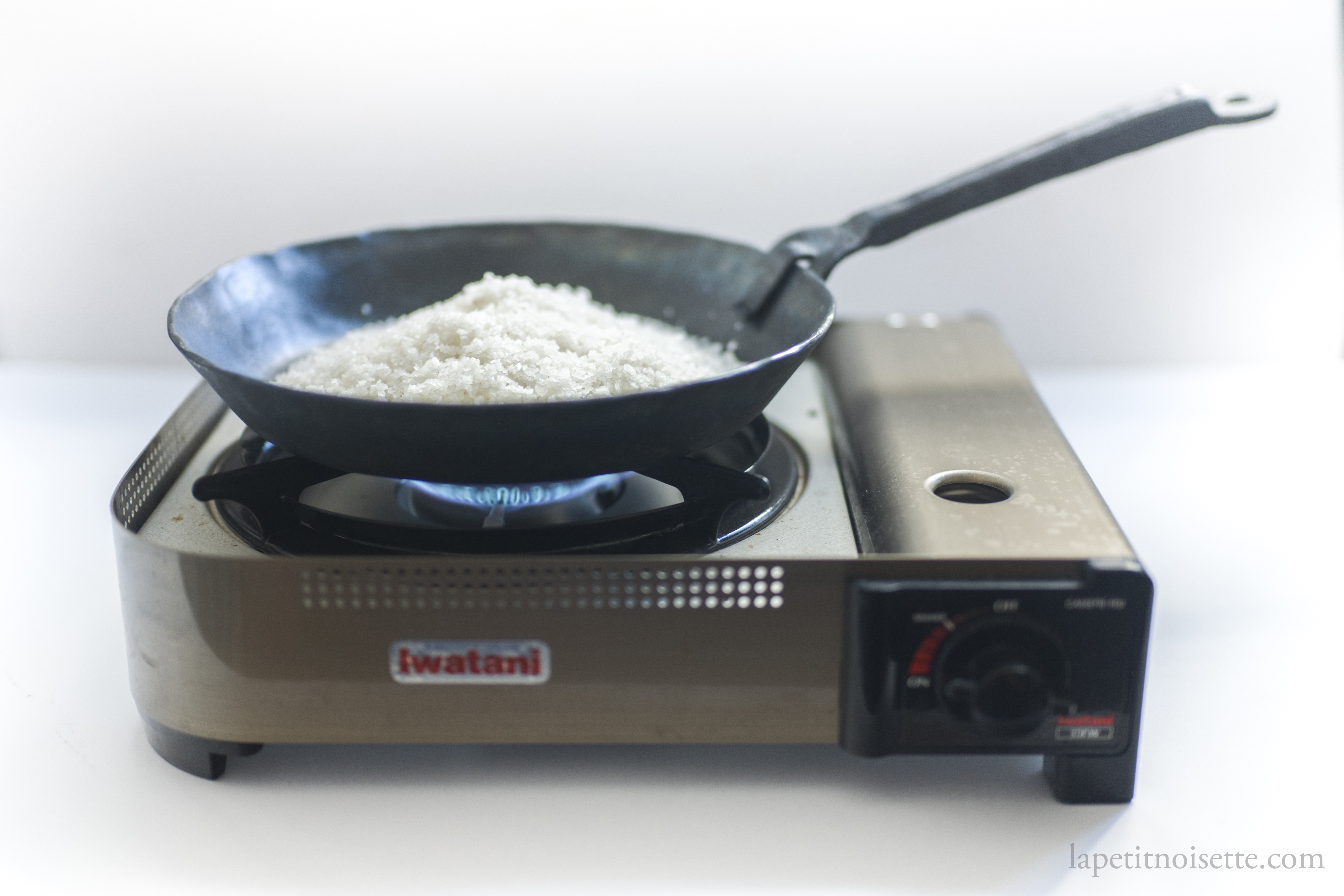 Drying sea salt over a flame for use in making sushi.