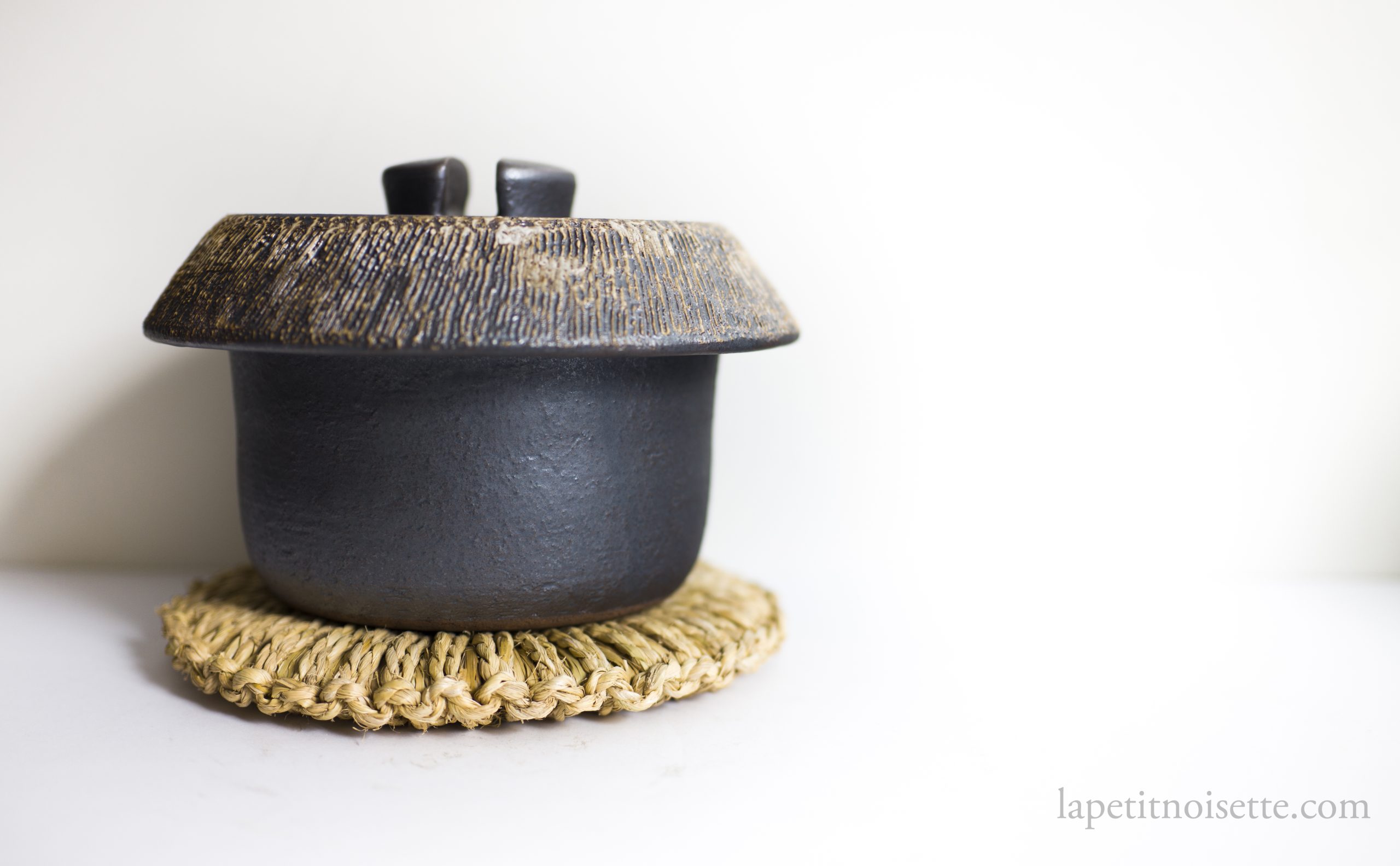 A traditional Japanese clay pot for cooking rice by Anraku Kiln.