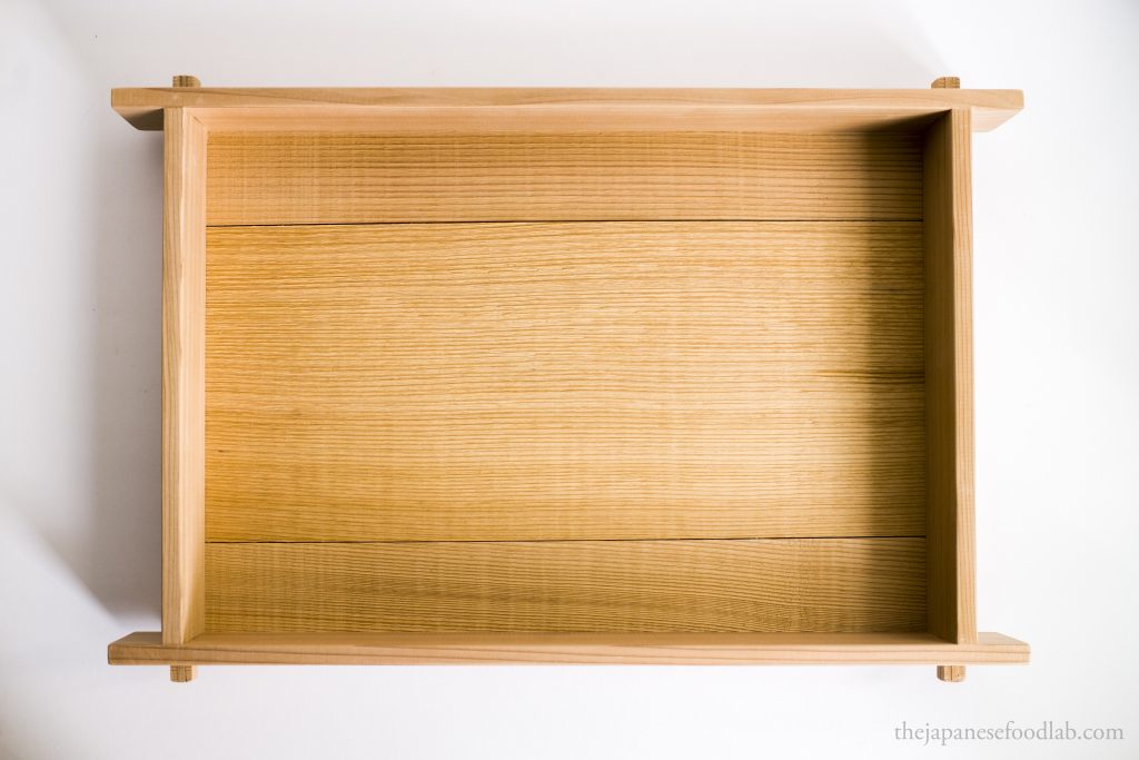 A traditional wooden tray used to grow koji.